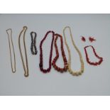 A collection of necklaces including early 20thC ivory, coral, cherry amber, gold plated, agate etc