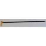 A 19thC walking cane with marine ivory handle and repoussé decorated collar marked 15ct G