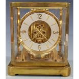 LeCoultre and Co Atmos clock, in brass case with white enamel chapter ring and alternate baton