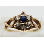 A 9ct gold ring set with a sapphire surrounded by paste, size N