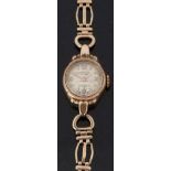 Accurist 9ct gold ladies wristwatch with gold hands and markers, sunburst dial and signed 21 jewel