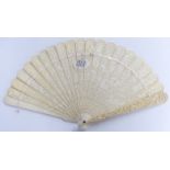 A 19thC Chinese carved ivory fan of 21 sticks each decorated with figural scenes to both sides,