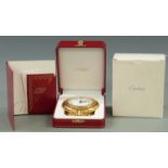 A Cartier desk alarm clock in original case and box. Brass case with folding stand, Roman dial,