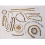 A collection of large gold tone necklaces and bracelets including Napier, Trifari, snake bangle etc