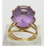 A 9ct gold ring set with an oval cut amethyst, size N