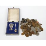 A cased hallmarked silver egg cup and spoon set, weight 51g and a quantity of coins including some
