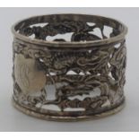 Chinese white metal embossed and pierced napkin ring with dragon decoration, with Chinese