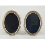 A pair of modern hallmarked silver oval photograph frames with easel backs, Sheffield 1985 maker