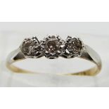 An 18ct gold ring set with three diamonds in a platinum setting, size I