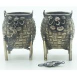 Pair of Chinese white metal salts formed as woven baskets on stands with articulated hanging fish,