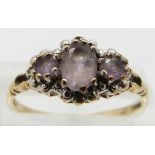 A 9ct gold ring set with amethyst and diamonds, size P