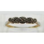 An 18ct gold ring set with five diamonds in an illusion setting, size L