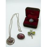 A silver pendant set with a millefiori cabochon by Caithness, a similar ring, a silver clover brooch