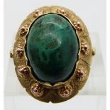 A 14k gold ring set with an azurite cabochon, with textured detail to the setting, marked W9H,  size