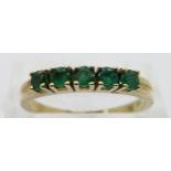 A 14ct gold ring set with emeralds, size P