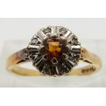 An 18ct gold ring set with a citrine and diamonds, size K