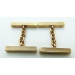 A pair of 9ct gold cufflinks made up of rectangular engine turned sections, 4.7g