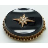 Victorian mourning brooch set with onyx, with seed pearls in a star setting to the centre and