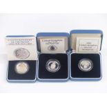 Three cased silver proof £1 coins 1983, 1988 and 1989