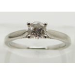 A platinum ring set with a round brilliant cut diamond of approximately 0.5ct, size K