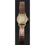 Huguenin 14ct gold ladies wristwatch with gold hands and baton markers, champagne face and signed 17