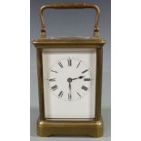 Early twentieth century French brass carriage clock in corniche style case, with white enamel dial
