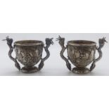 Pair of Chinese white metal open salts with embossed decoration of figures and buildings, the