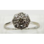 An 18ct gold ring set with diamonds in a platinum cluster, size N