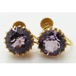 A pair of 9ct gold earrings set with an amethyst to each