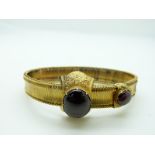 Victorian Etruscan Revival gold bracelet set with two large foiled garnets and engraved