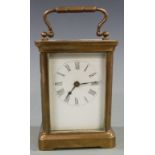 Early to mid twentieth century brass carriage clock in corniche style case, with white Roman dial