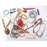 A collection of costume jewellery, necklaces including bone, agate, pearl, amber, coral and