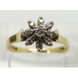 An 18ct gold ring set with diamonds in a flower cluster, size M