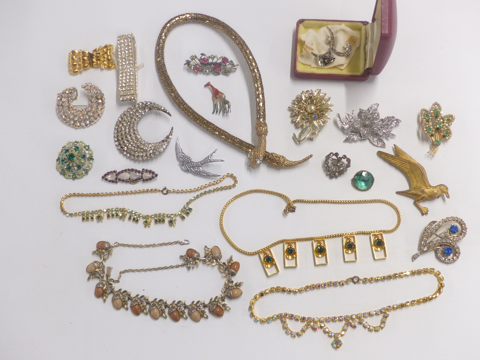 A collection of costume jewellery including brooches, snake necklace etc