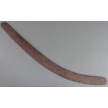 A 19thC Australian Aboriginal boomerang or throwing stick with carved parallel lines and adzed