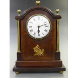 Georgian mantel clock, the enamel Roman dial with steel spade hands, the inlaid mahogany veneered