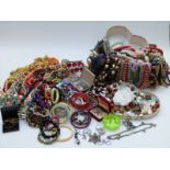 A collection of costume jewellery including earrings, beaded necklaces, silver pendant set with an
