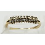 A 9ct gold half eternity ring set with diamonds in two rows (size N)