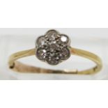 An 18ct gold ring set with diamonds in a cluster, size K