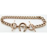 A 9ct rose gold curb link bracelet with horseshoe and bridle decoration and four spare links, 8.8g