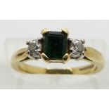 An 18ct gold ring set with an emerald and diamonds