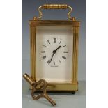 Twentieth century brass carriage clock by Lionel Peck of London, with white Roman dial and