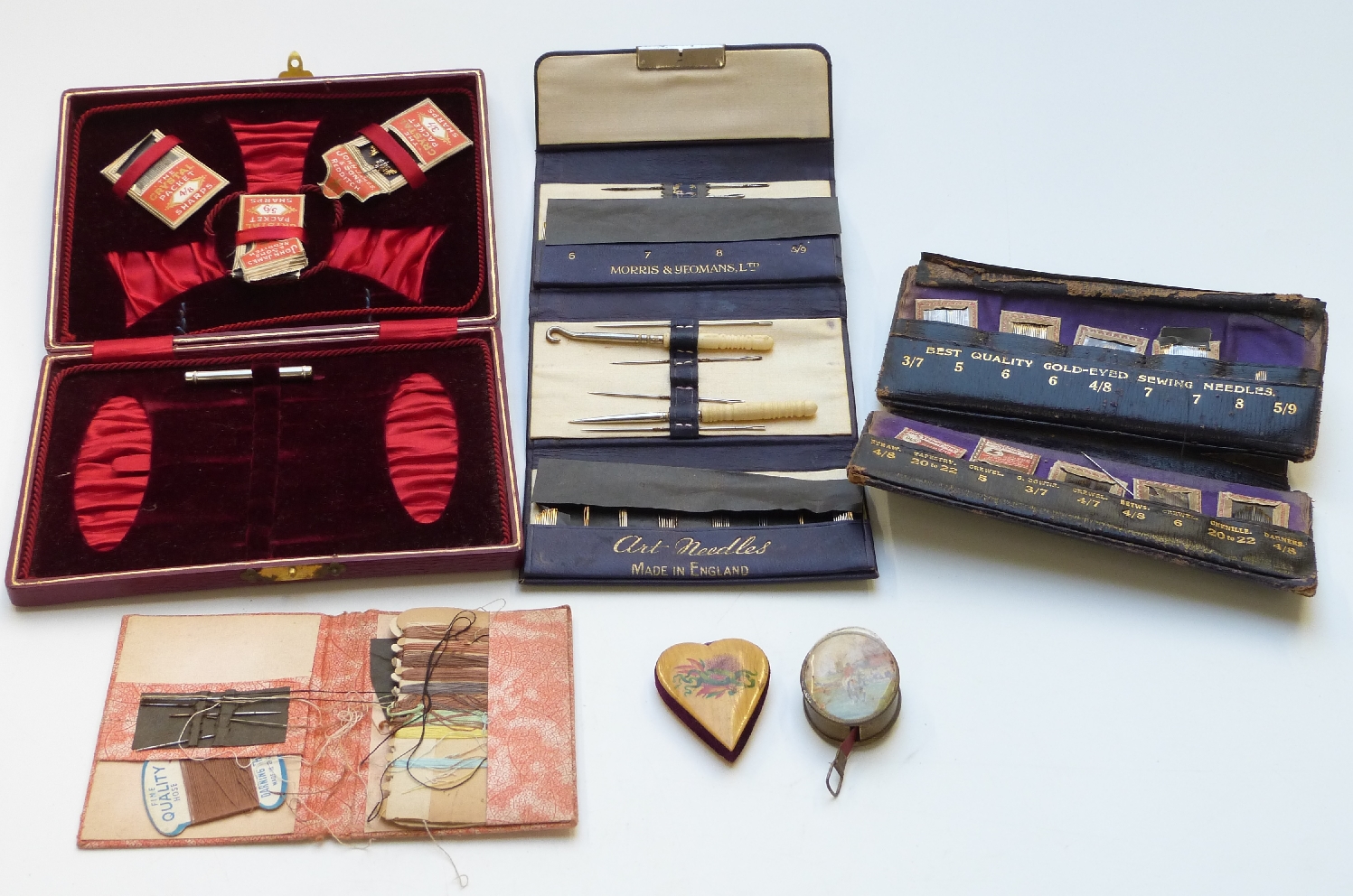 A collection of needlework / sewing items including several leather needle cases with some