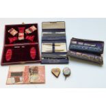 A collection of needlework / sewing items including several leather needle cases with some