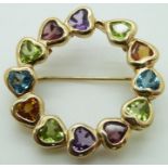 A 14ct gold brooch set with heart cut garnets, amethysts, peridot, topaz and citrine