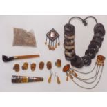 Collection of amber items including brooches, pipe, cufflinks, beads, etc