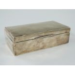 A hallmarked silver cigarette box with engine turned lid, marks rubbed, length 16.5cm