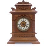 Ansonia oak table/mantel clock in carved case, Roman dial, Beetle and Poker hands, striking on a