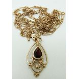 A 9ct gold pendant set with a garnet on a 9ct gold chain, 4.1g