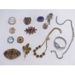 A collection of costume jewellery brooches, two crystal necklaces and a watch